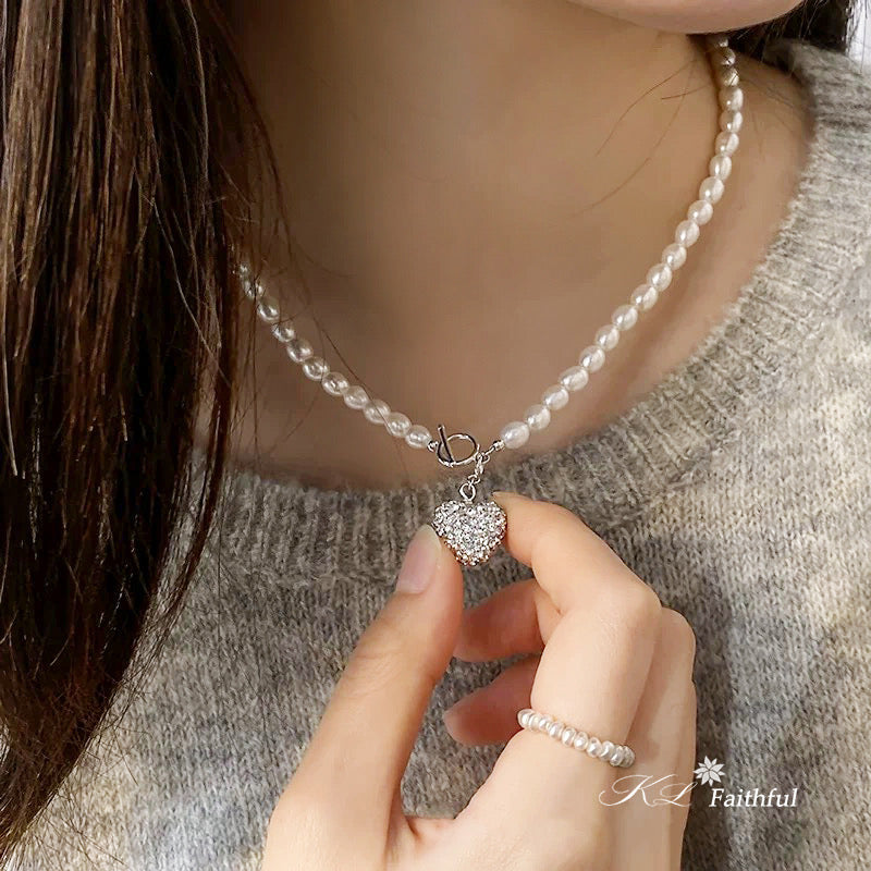 Gold pearl heart necklace styled with knitwear