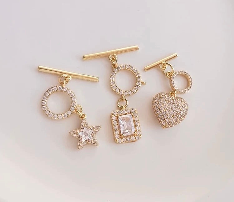 Gold toggle clasp pearl necklaces with heart, star, and rectangle pendant